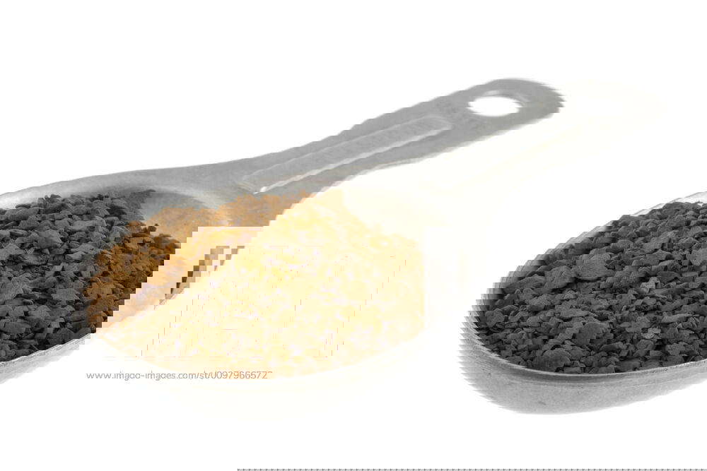 Tablespoon of instant coffee granules granules of instant coffee on old