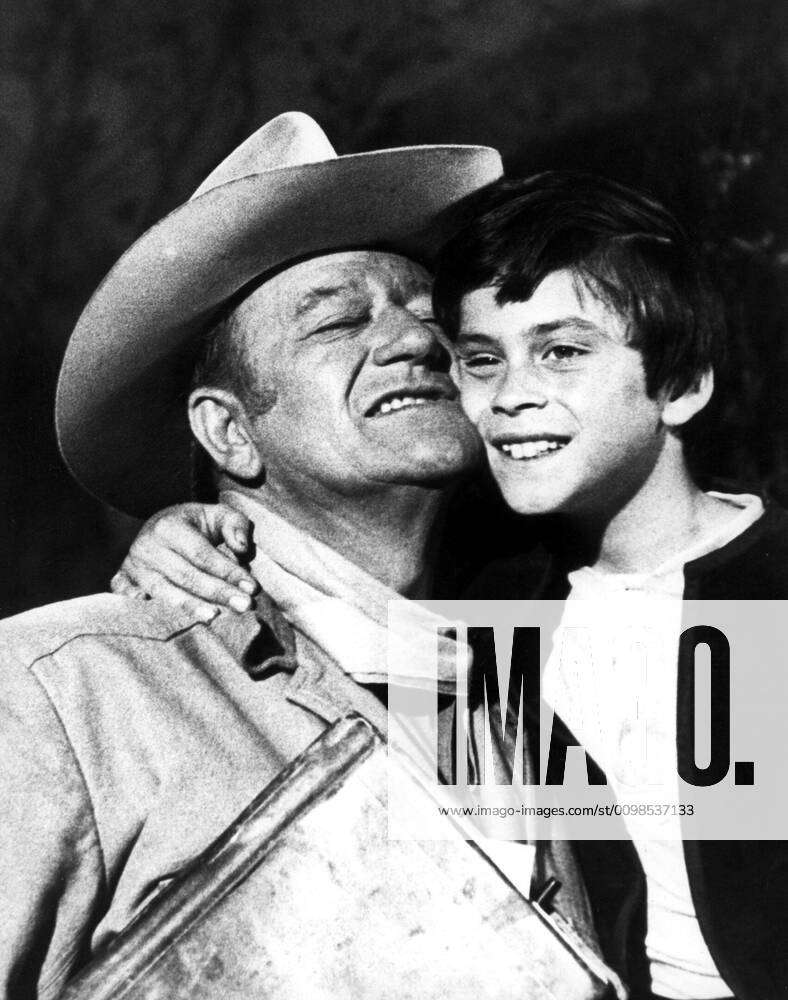 BIG JAKE, John Wayne gets a hug from son Ethan Wayne during production ...
