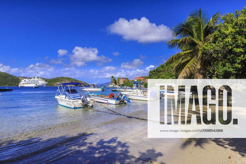 Les Saintes Bay at Anse Mire Cove beach, boats, turquoise sea, palm ...