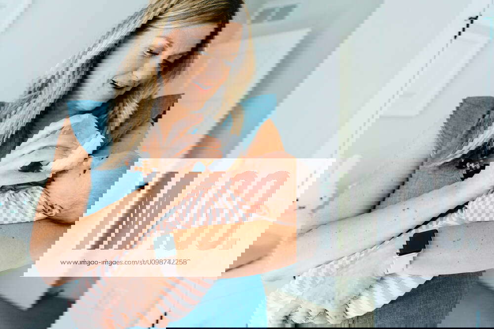 Closeup portrait of a mother bottle feeding her newborn baby girl