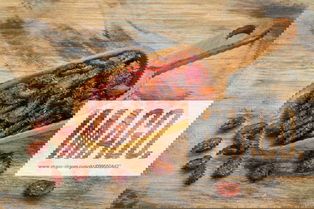 Dried cranberries scoop of dried cranberries on a grunge painted wood