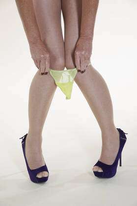 Woman pulling panties over her knees Woman s panties around knees Y