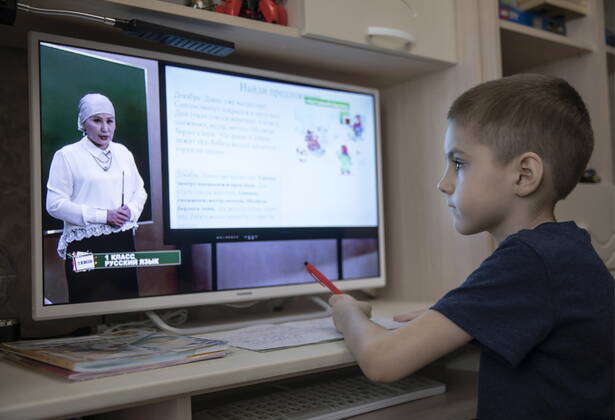 GROZNY, RUSSIA - : A boy does homework for Teleshkola, a remote ...