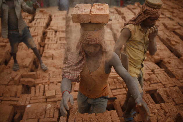 Bhaktapur, Nepal: Laborers balance bricks on their head at a brick kiln ...