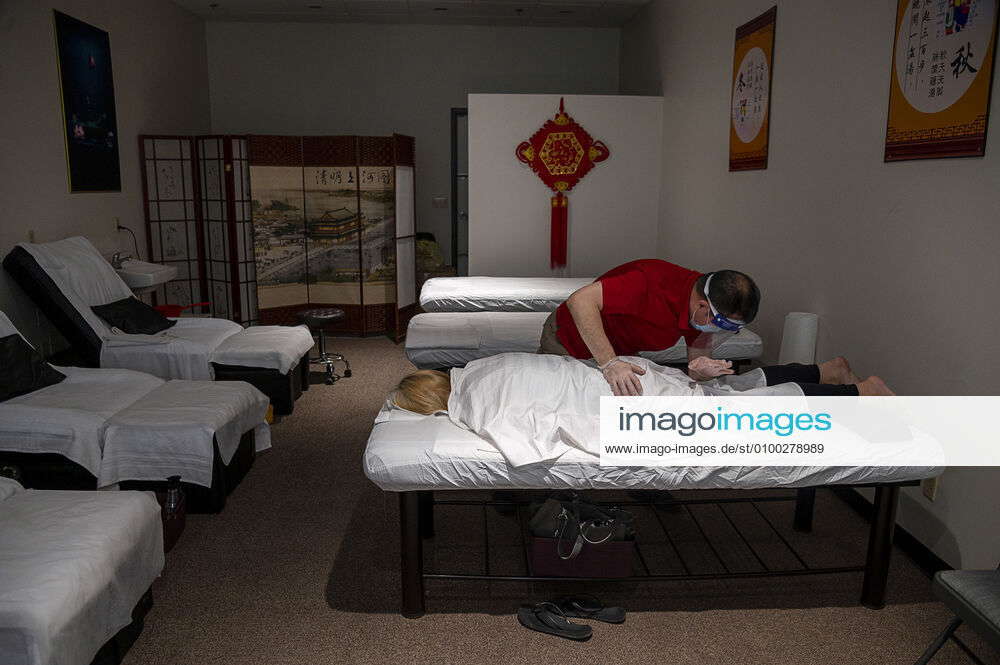 May 6, 2020, Yuba City, CA, USA Zhen Wan of YW Massage wears gloves, a