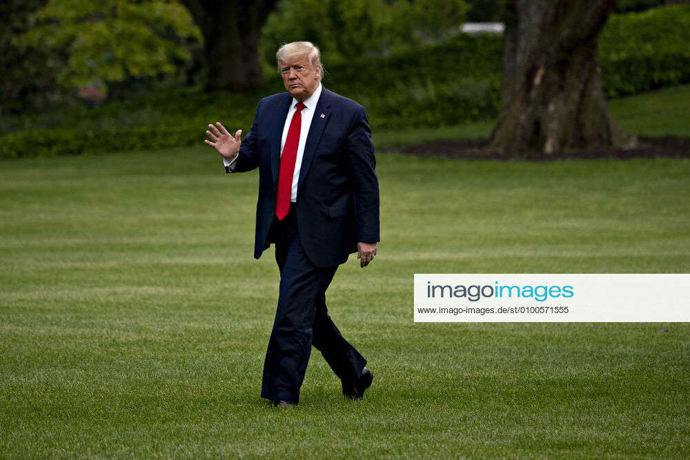 United States President Donald J. Trump waves while walking on the ...