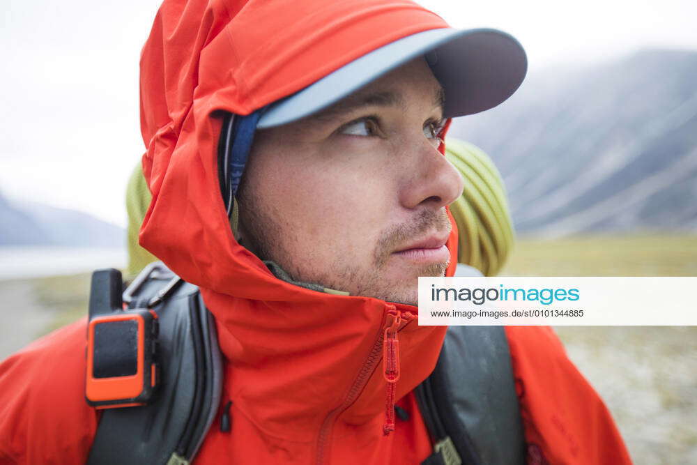 Close up portrait of climber wearing waterproof jacket and hood