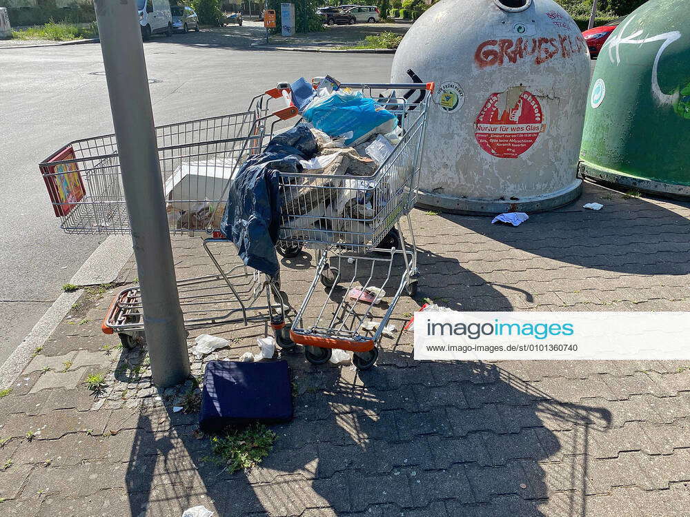 Shopping trolley filled with various kinds of waste, bags, plastic bags