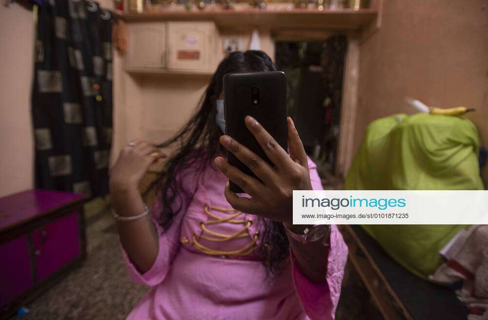 1000px x 656px - PUNE, INDIA - JUNE 25: A sex worker during a video call in the red light  area