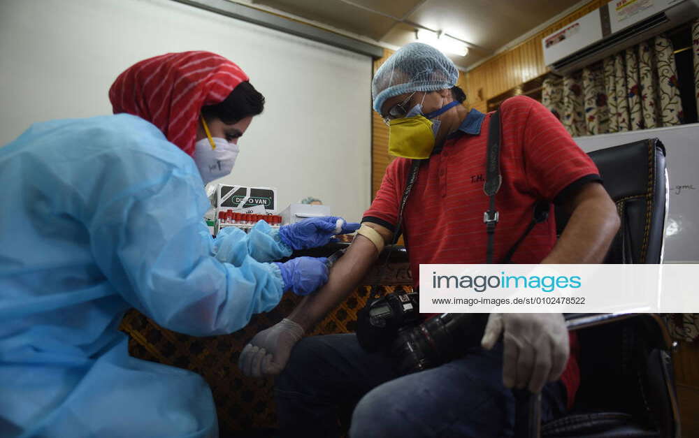 SRINAGAR, INDIA JULY 15 A doctor collects a blood sample from a