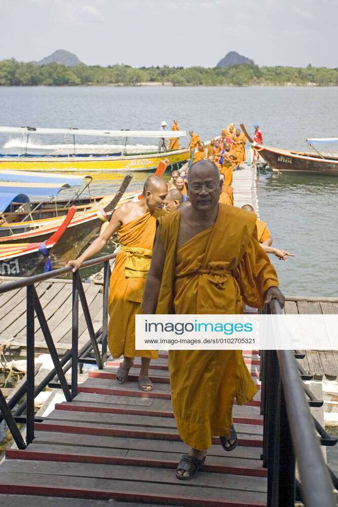 Saffron robe Buddhist monks visit Ko Panyi Muslim fishing village