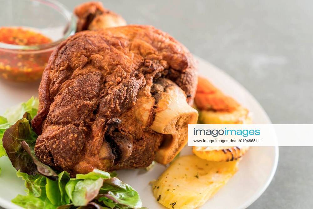 Crispy pork knuckle or German Pork Hocks on white plate