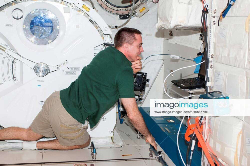 Nasa Astronaut Chris Cassidy Expedition 36 Flight Engineer Looks At A Computer Monitor In The