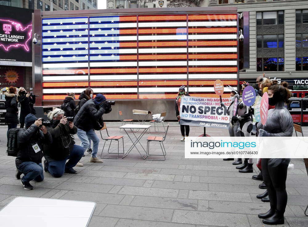 PETA protesters wearing body paint to look like animals hold up signs