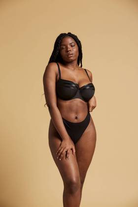 Curvy beautiful African American woman with braids in lingerie