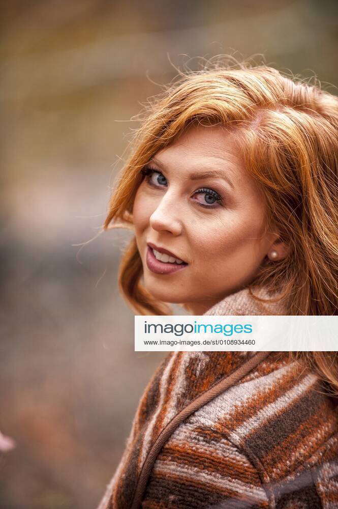 Portrait Of A 25 Year Old Redheaded Woman In A Forest Setting