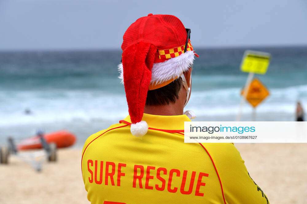 CHRISTMAS DAY BONDI BEACH, A Surf lifesaver is seen on a windy and ...