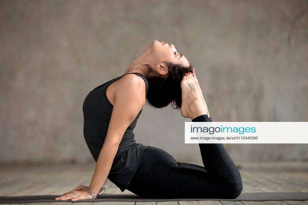 Young yogi woman practicing yoga concept, doing King Cobra exercise, Raja  bhudjangasana pose, working out wearing black sportswear, full length  silhou Stock Photo - Alamy