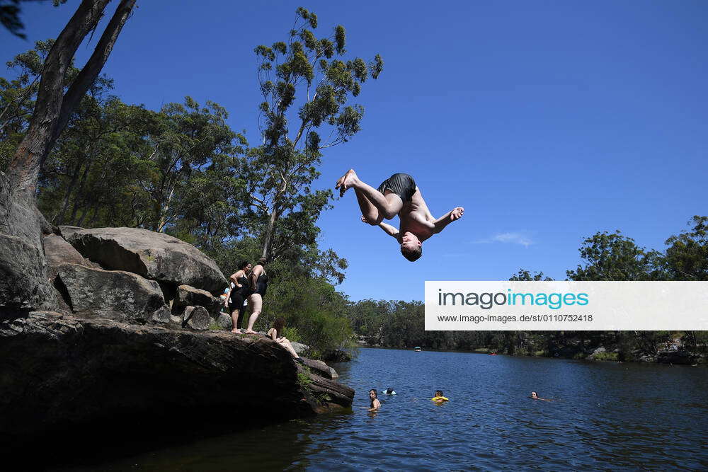 HOT WEATHER SYDNEY Ethan Burton is seen jumping off a rock at