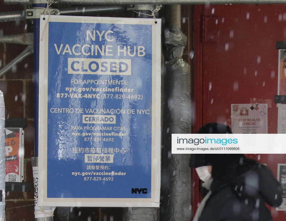 An NYC Vaccination Hub Closed sign hangs outside of a school used to ...