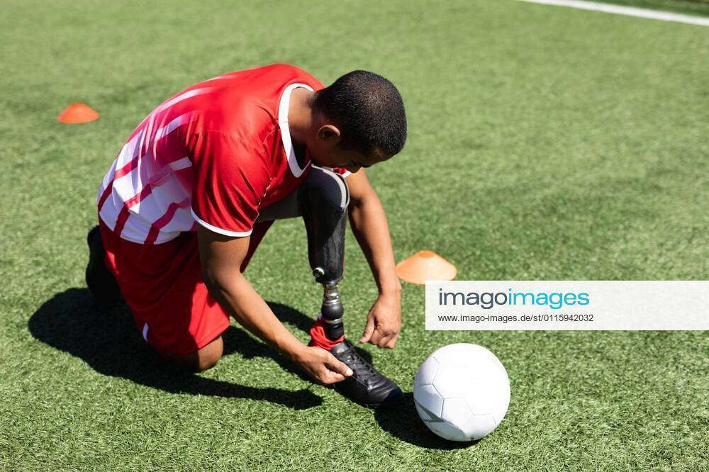 Mixed race male football player with prosthetic leg at a sports field