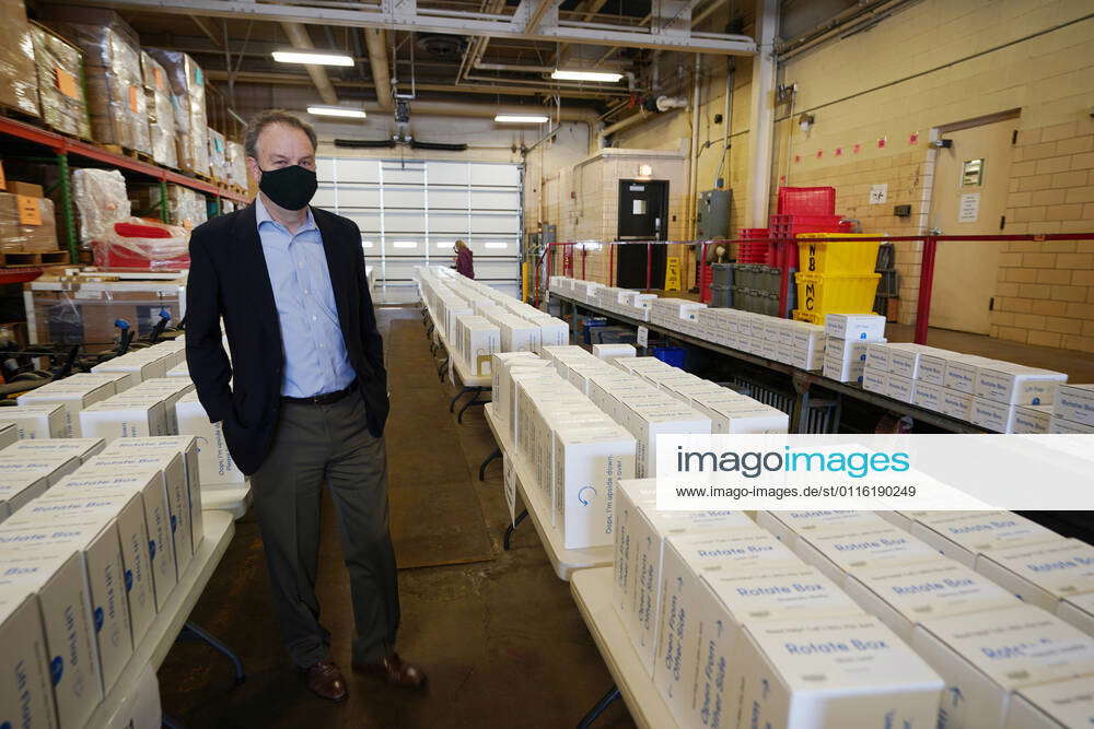 St. Louis County Executive Dr. Sam Page, looks over some of the 1,500 tablets being given away at