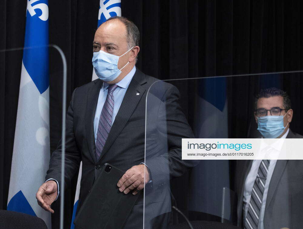 April 29, 2021, QUEBEC, PQ, Canada Quebec Health Minister Christian Dube, left, walks in a news