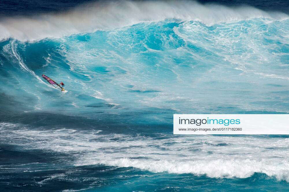 USA, Hawaii, Maui. Robby Naish windsurfing monster waves at Pe ahi Jaws ...