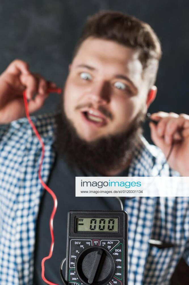 Male service engineer jokes with multimeter model released, Symbolfoto