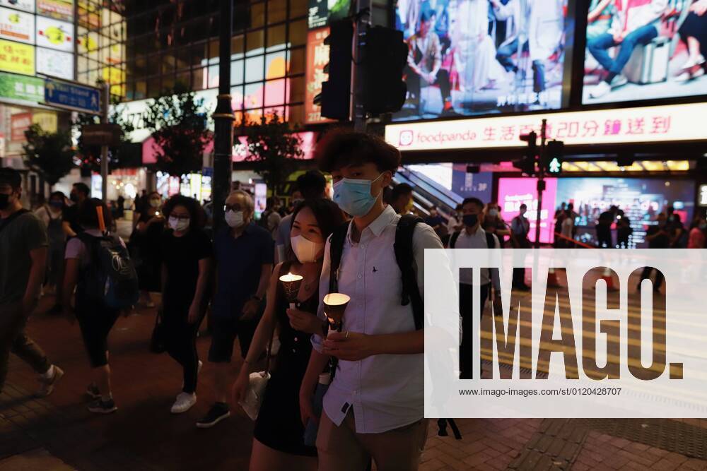 June 4, 2021, HONG KONG, CHINA Young couple walk through street at
