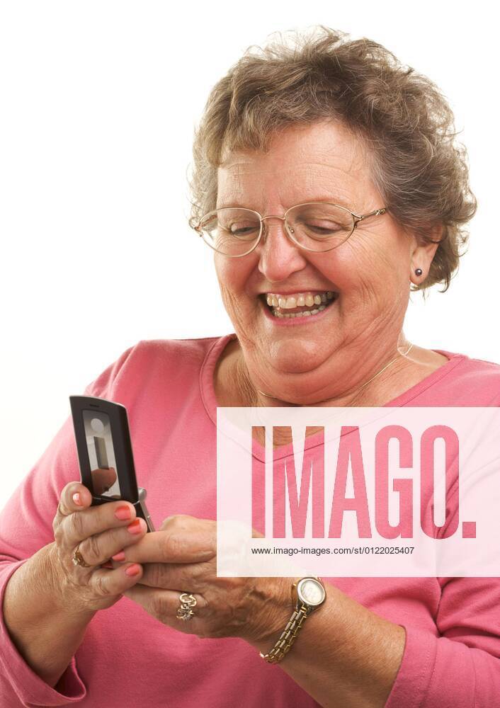 an-older-woman-with-glasses-is-sitting-in-front-of-a-mirror-and-looking