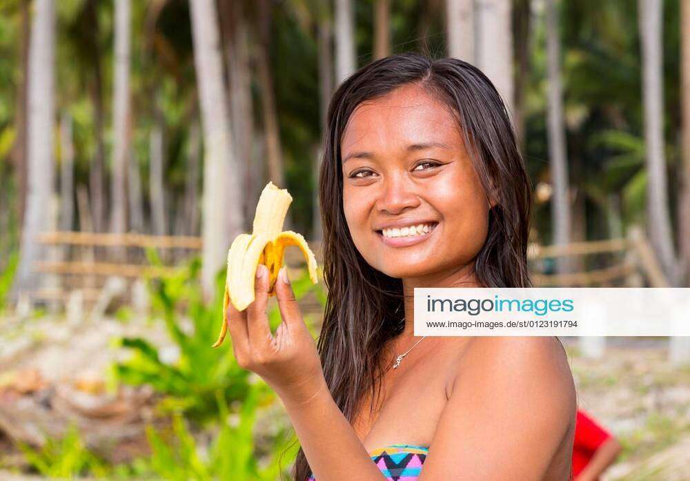 Filipina Beautiful Girl Eats A Banana In Nature Xfotosearchxlbrfx