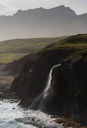 Waterfall, surf and mountains, Breiðavík, East Fjords, Víknaslódir