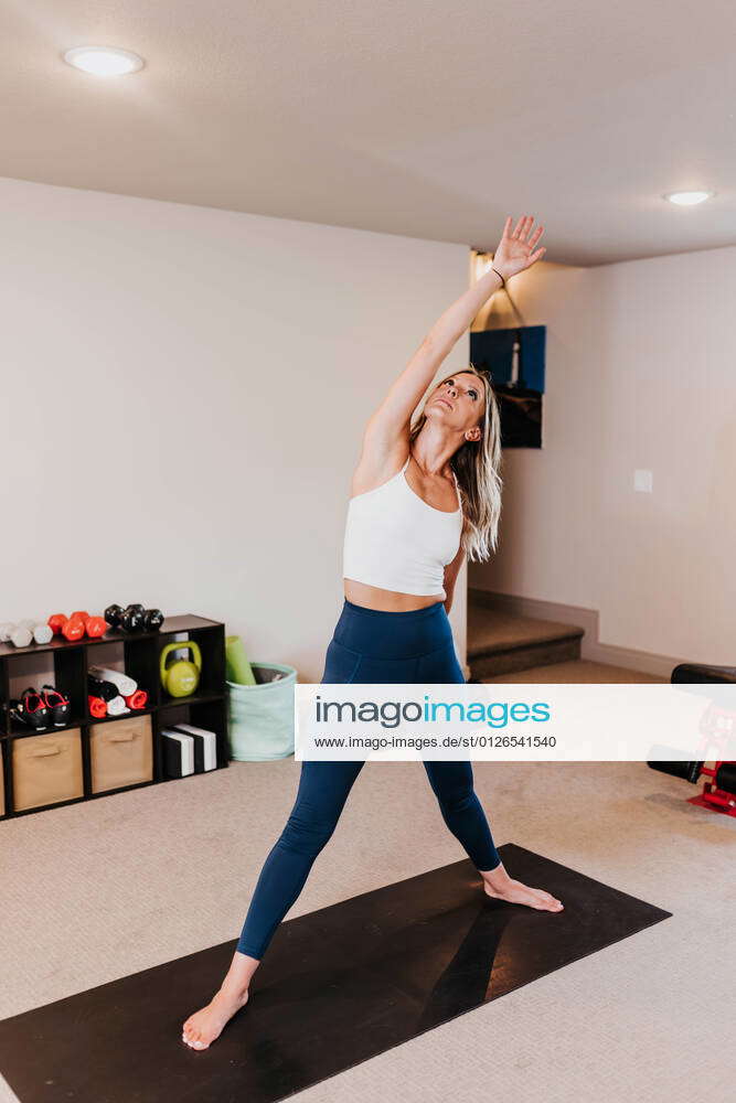 Woman does yoga in her home gym Sioux Falls, SD, United States CR