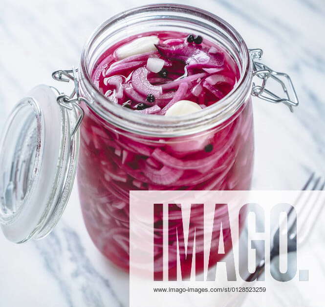 Jar of pickled Spanish onions with garlic and black pepper