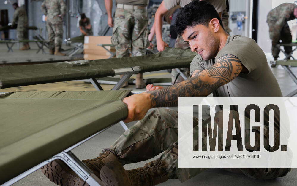 STYLELOCATIONA U.S. Air Force airman sets up a cot during preparations