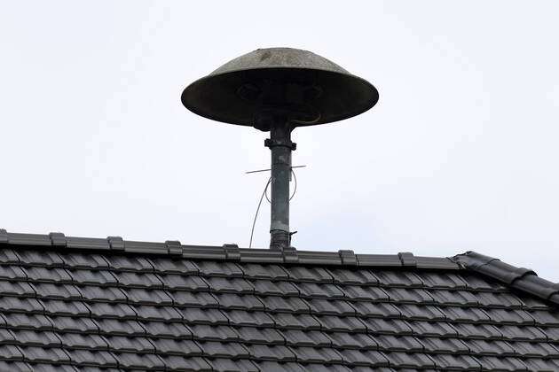 A warning siren of the type motor siren E57 on a roof in the Eifel