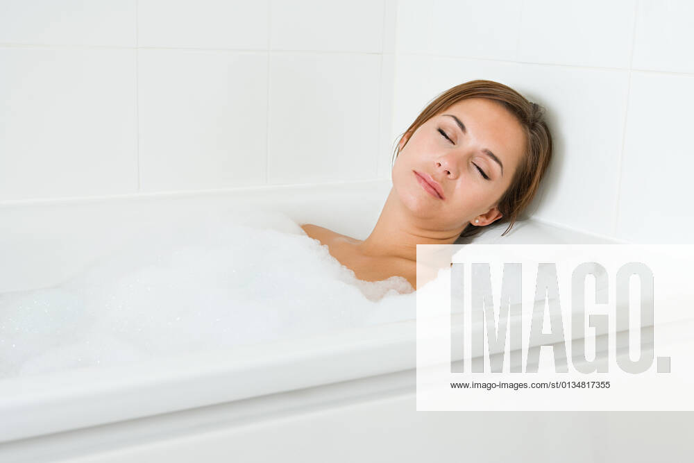 Woman sleeping in bath