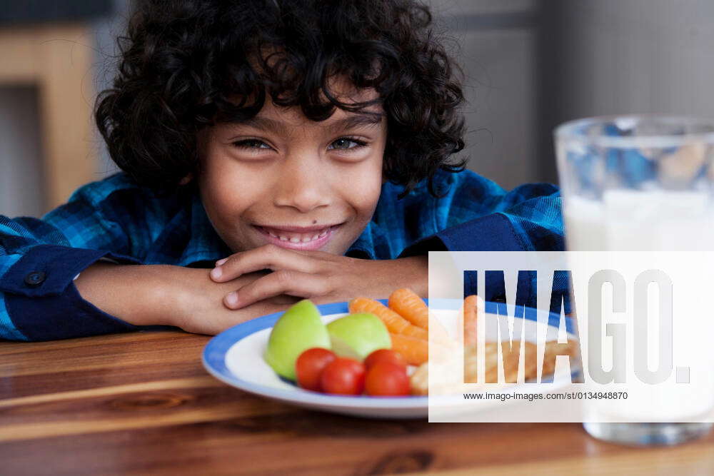 boy-smiling-with-snacks-and-glass-of-milk