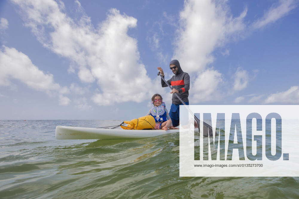 Father and daughter paddle boarding in the Gulf of Mexico, Destin