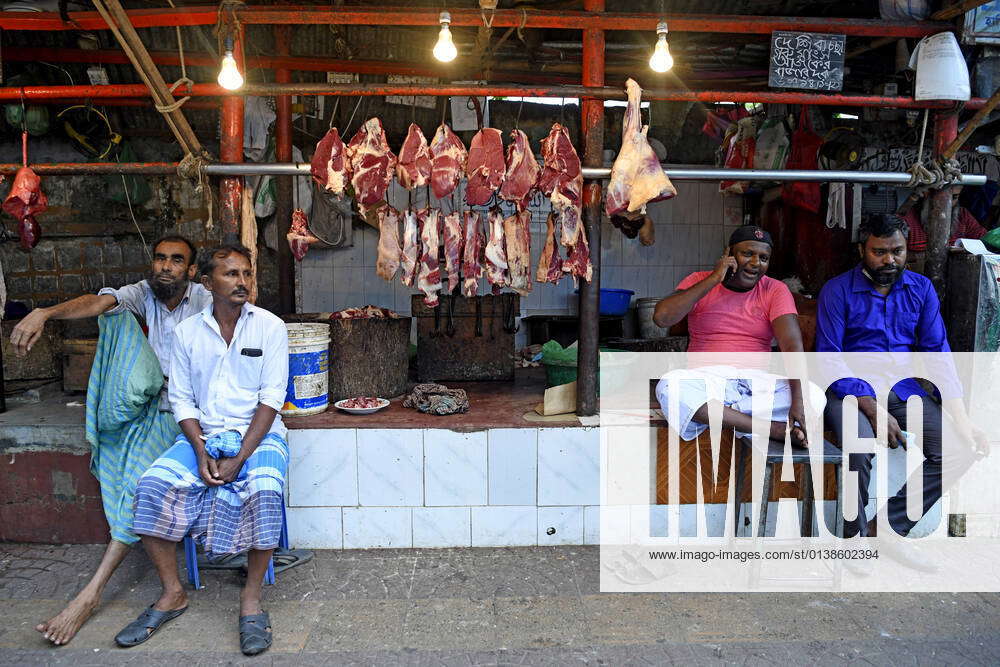 October 14, 2021, Dhaka, Bangladesh Meat seller sits with his