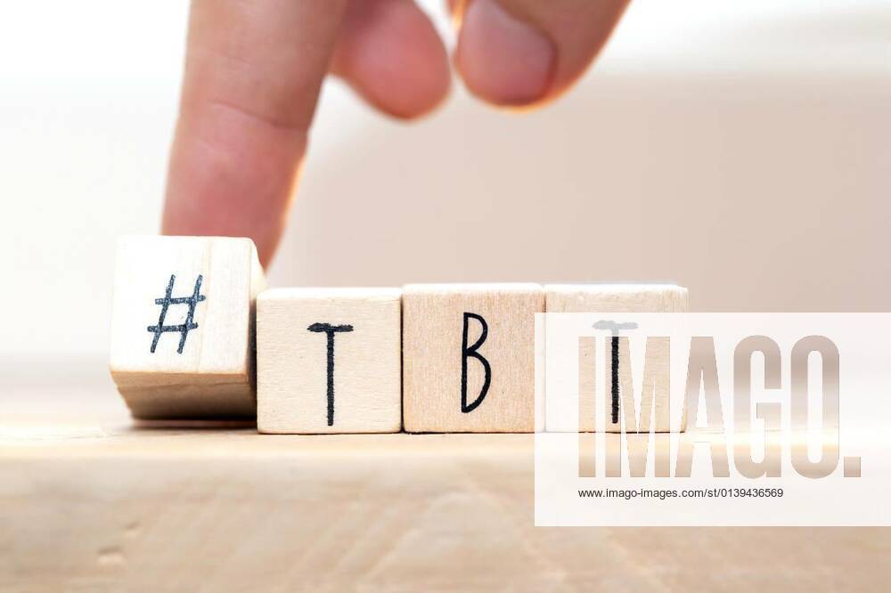 Wooden cubes with Hashtag tbt, meaning Throwback Thursday near white