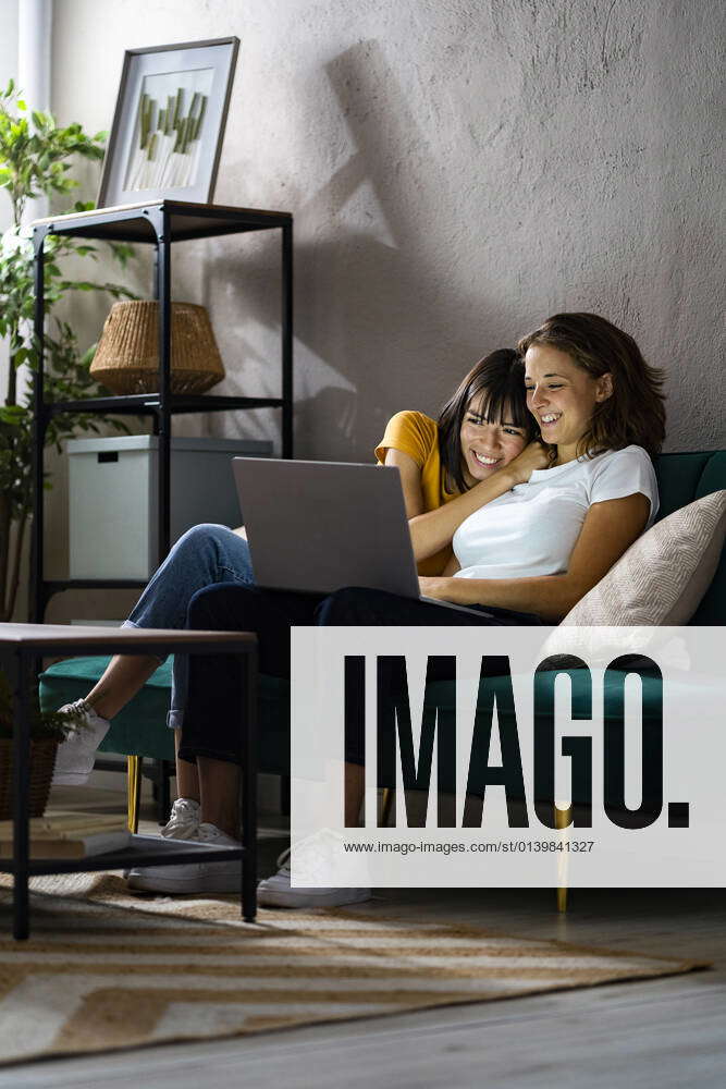Happy Lesbian Couple Using Laptop While Sitting At Home Model Released Symbolfoto Property Released 4137