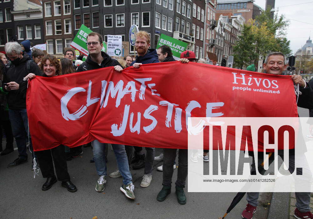 Activists holds a banner asking climate justice attend the global day