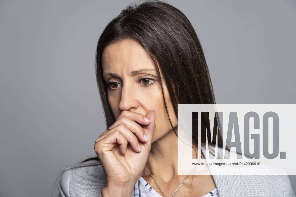 Thoughtful Mature Woman Touching Her Mouth
