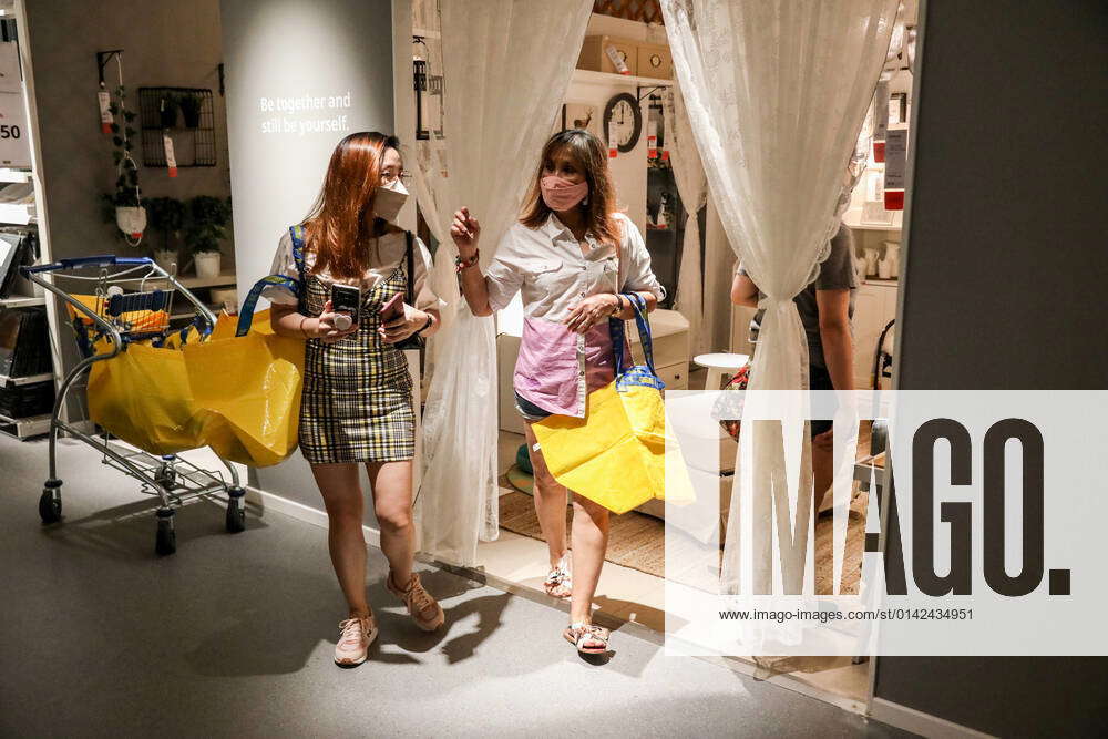 November 20, 2021 People wearing protective masks view furnitures