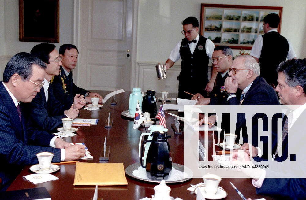 U.S. Secretary of Defense Les Aspin, (seated right center) hosts a ...