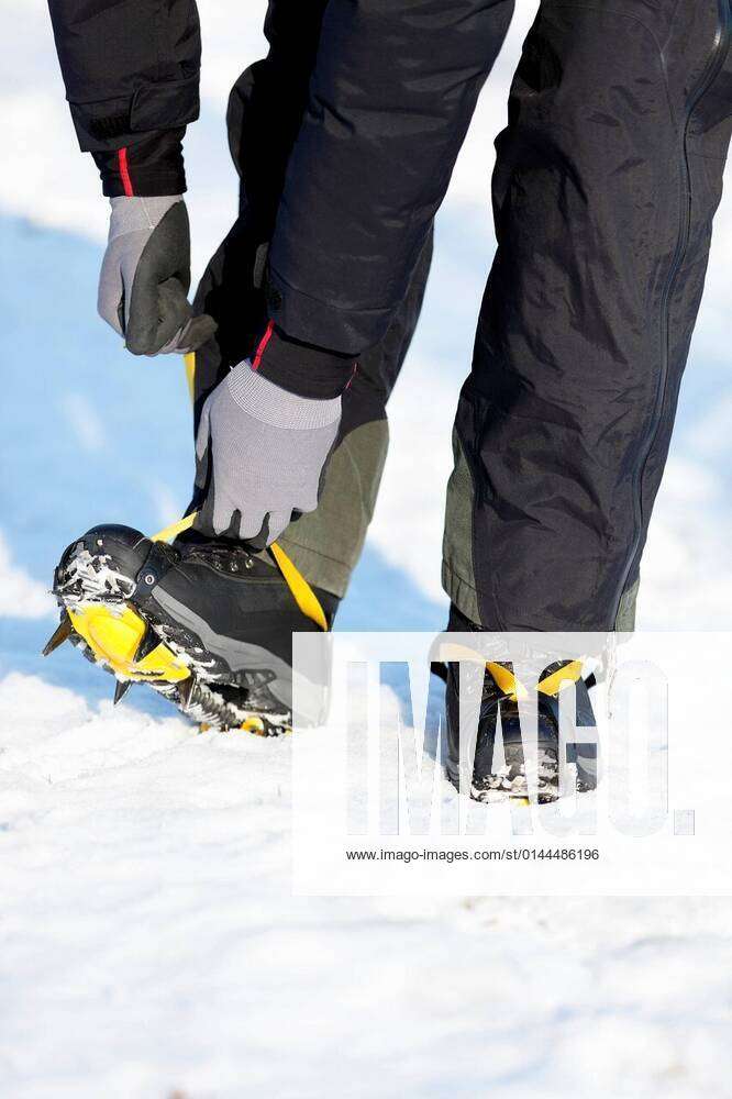 Crampons closeup. Crampons closeup. Crampon on winter boot for