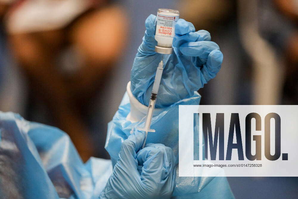 January 6, 2022, Manila, Philippines A health worker transfers a dose