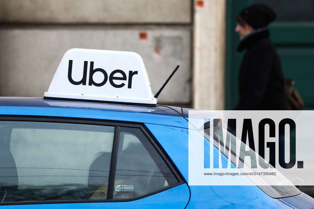 Daily Life And Economy In Krakow Uber sign is seen on a car in Krakow
